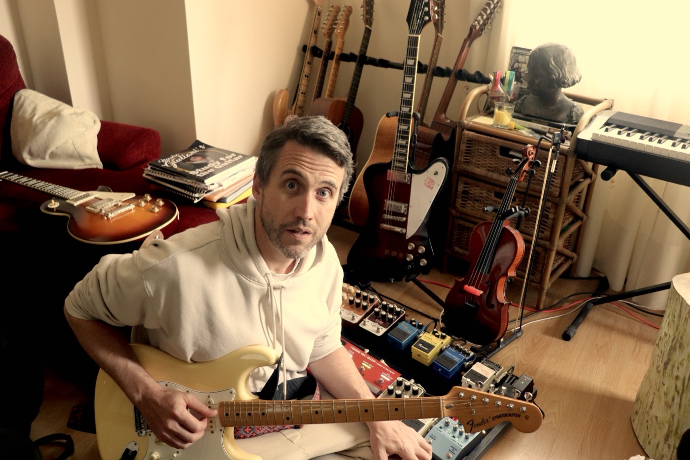 Will Worth in the studio with guitars and recording equipment